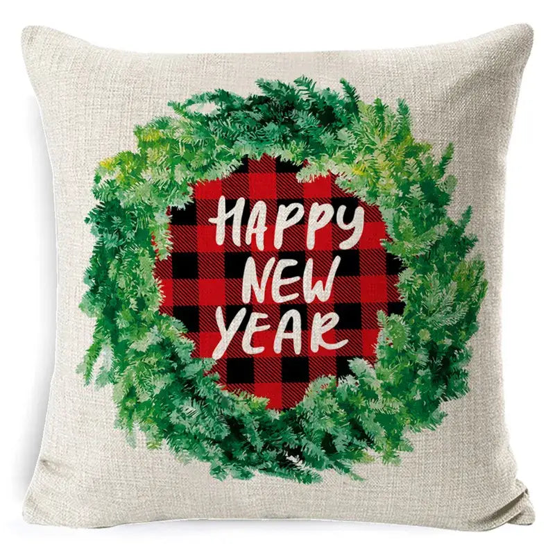 Beige linen throw pillow with festive green wreath red and black plaid center and happy new year text elk print linen decorbites