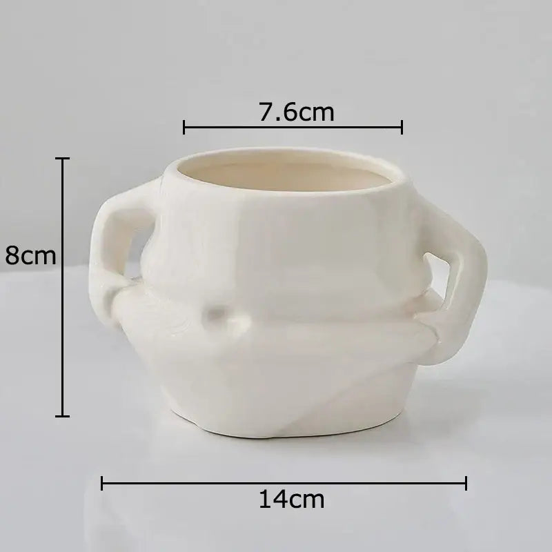 Cream-colored ceramic planter with two sculpted handles and textured rounded body in festive white santa claus ceramic mug set