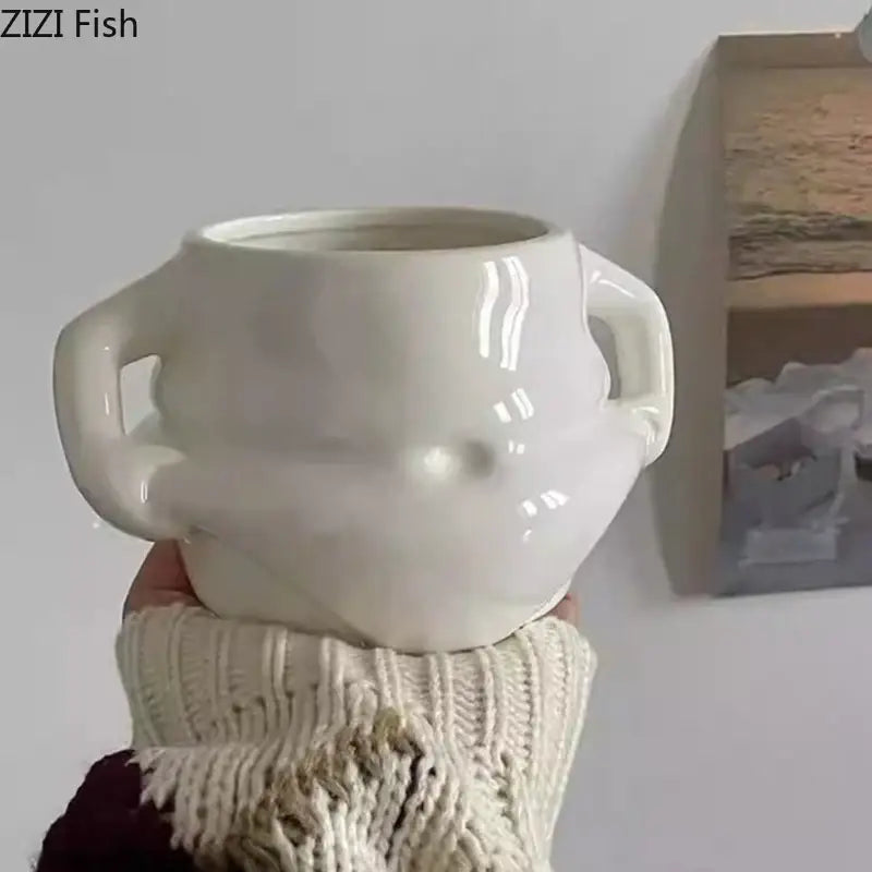 Cream-colored ceramic planter with two sculpted handles and glossy finish from festive white santa claus ceramic mug set