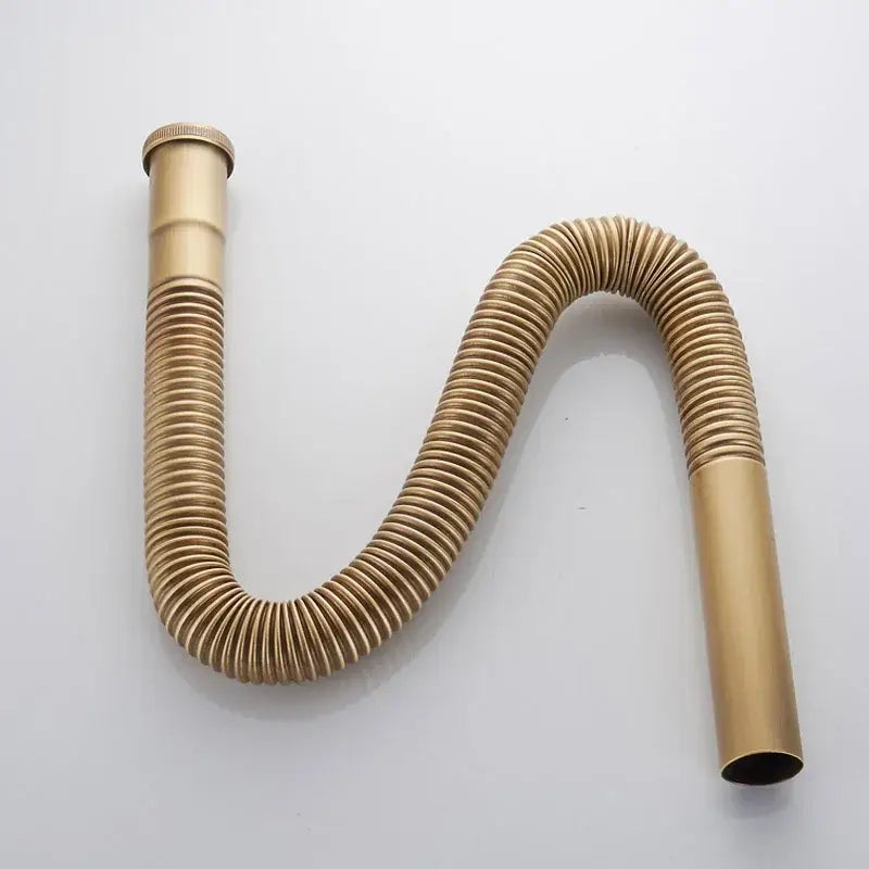 Gold-colored flexible chrome brass siphon sink drain pipe with ribbed texture and threaded ends for kitchen sink drain