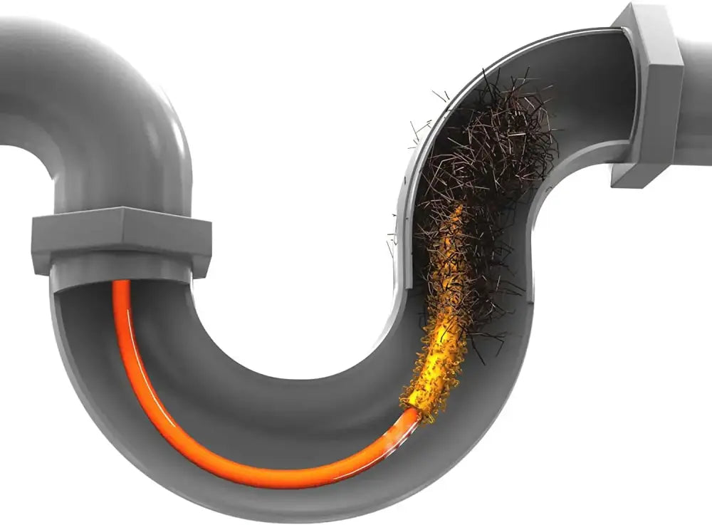 Flexible orange and yellow plastic drain cleaner brush clearing gray sink drain clogged with hair and debris