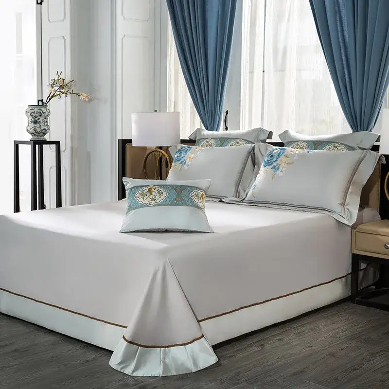 Elegant white satin floral 200s embroidered egyptian cotton bedding set with gold trim and soft blue pillows