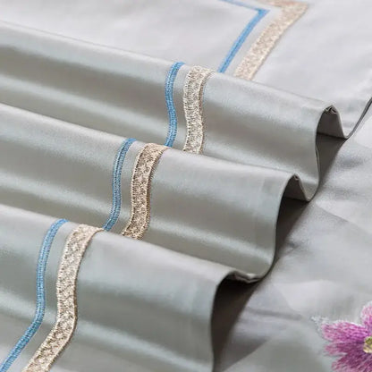 Light gray satin pillowcase with delicate blue and gold embroidered trim from floral 200s embroidered egyptian cotton bedding set