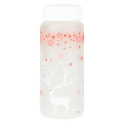 A frosted glass water bottle with a white lid featuring pink floral patterns and a white deer silhouette against a soft gradient background
