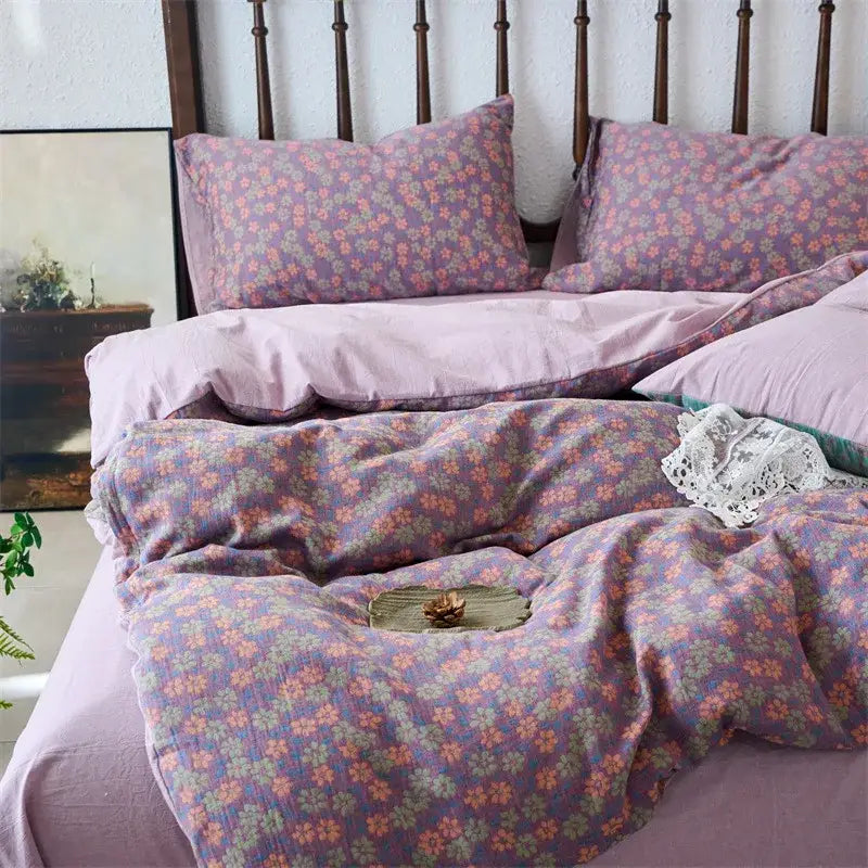 Purple floral duvet cover set with soft textured fabric featuring delicate pink and green blossoms for bedroom use