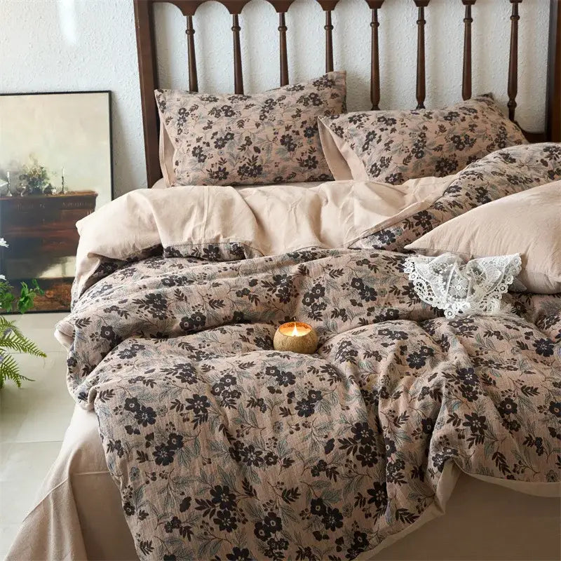 Beige floral duvet cover set with black and muted green botanical prints on soft textured cotton fabric