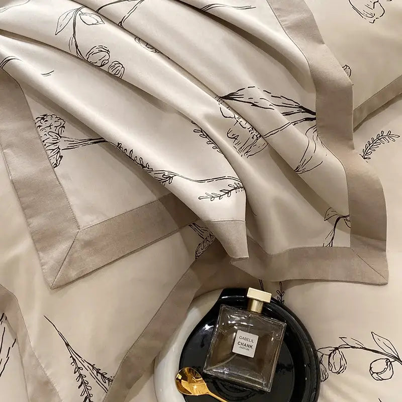 Beige satin egyptian cotton bedding set with delicate black botanical line drawings and matching pillowcases