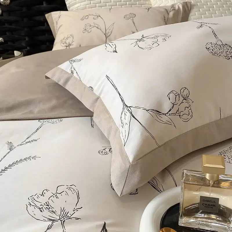Beige pillowcases with delicate black floral line patterns in a floral beige egyptian cotton bedding set