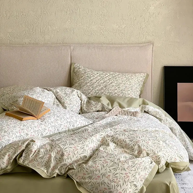 A soft cream-colored floral beige egyptian cotton bedding set with delicate botanical print in muted greens and pinks