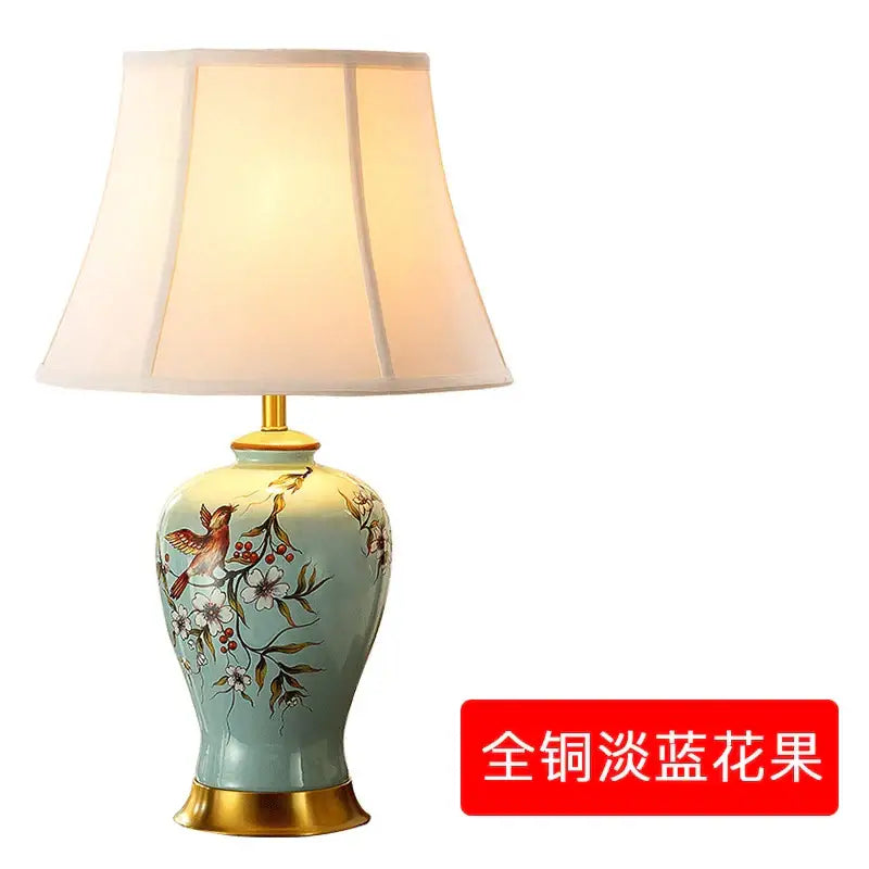 A delicate light blue ceramic table lamp with gold accents and floral bird motifs for living room decorbites ceramic vase