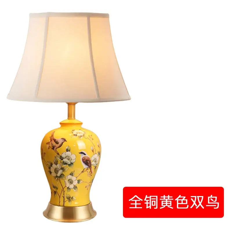 Floral bird ceramic vase table lamp with yellow hand-painted birds and flowers and gold-toned metal base for living room decorbites