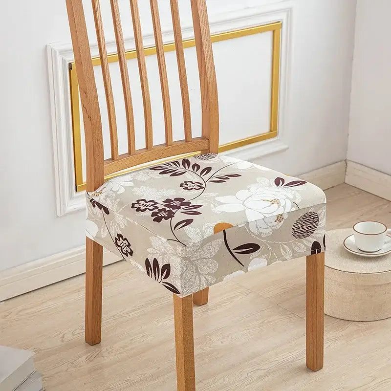 Beige floral-patterned elastic print chair cover with brown and white blossoms for dining room chairs