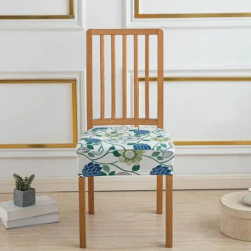 A floral blue and green elastic print chair cover on a wooden dining chair for dining room use