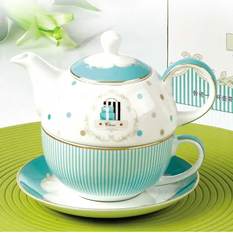 A white ceramic bone china tea set with a turquoise lid and polka dots paired with a striped cup and saucer set