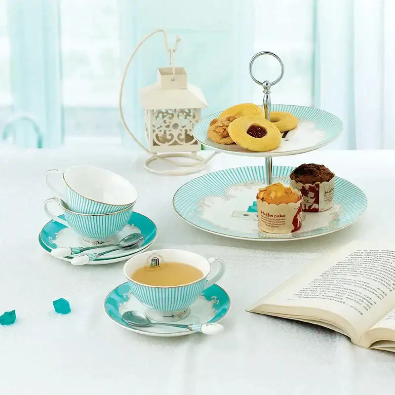 Floral blue and white bone china tea set with turquoise and white striped porcelain cups saucers and spoons gold trimmed