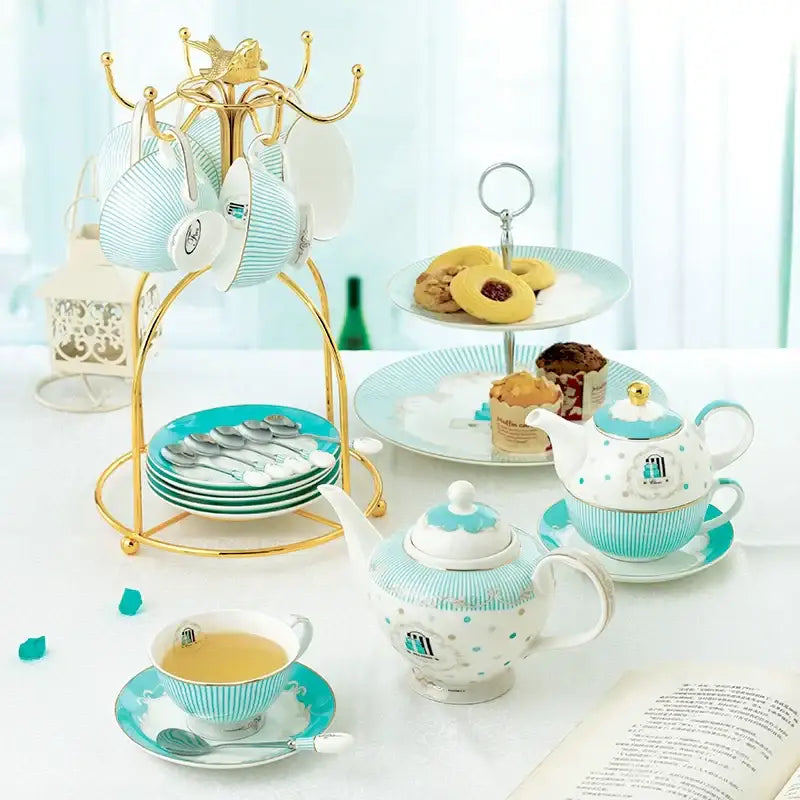 A delicate turquoise and white bone china tea set teapot with gold trim and polka-dot pattern for dining room use