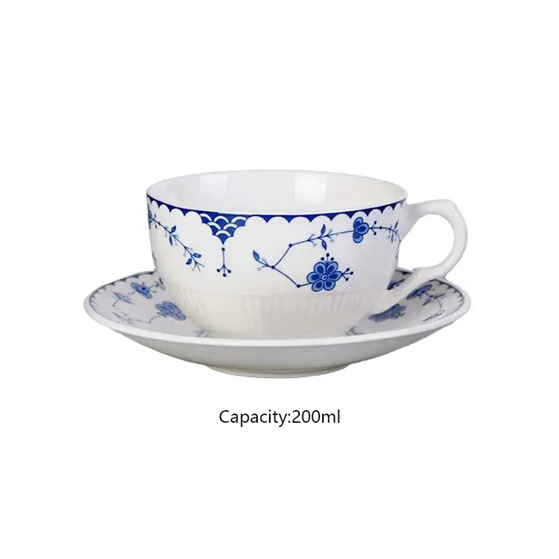 White porcelain teacup and saucer set with delicate blue floral patterns complement decorbites ceramic dinner plate