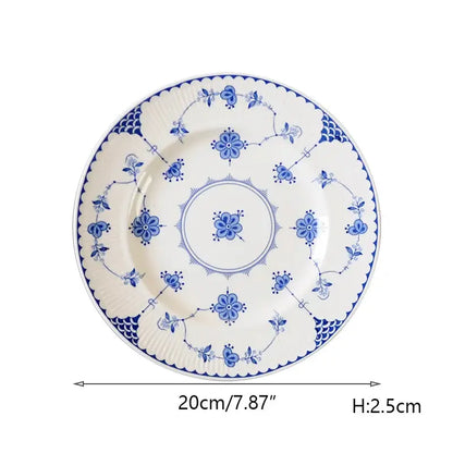 A white ceramic dinner plate with intricate blue floral and vine patterns from decorbites ceramic dinnerware