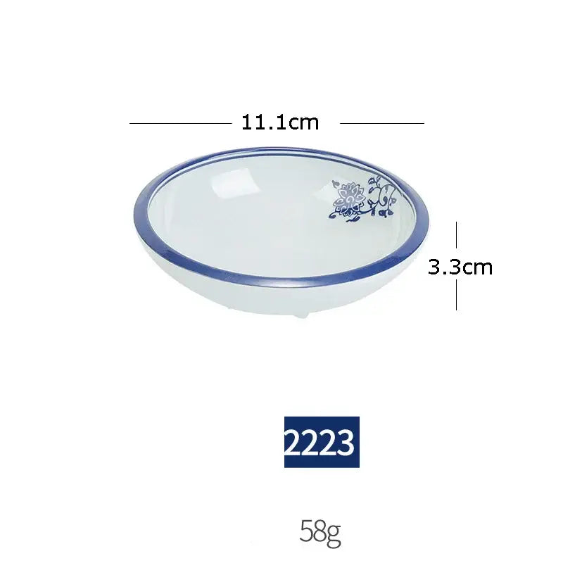 White imitation porcelain bowl with blue floral design and rim from floral blue and white imitation porcelain dinner set