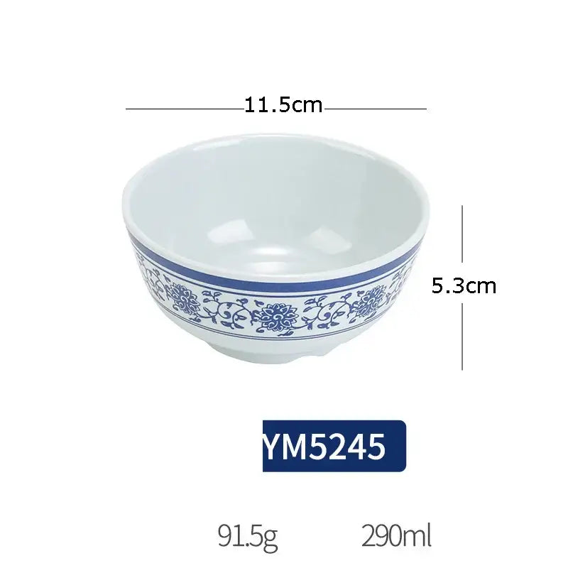 White ceramic bowl with blue floral vine pattern rim part of floral blue and white imitation porcelain dinner set
