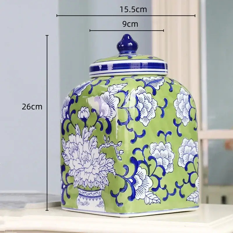 A square-shaped green ceramic jar with blue and white floral patterns and a matching lid for living room decorbites blue white porcelain