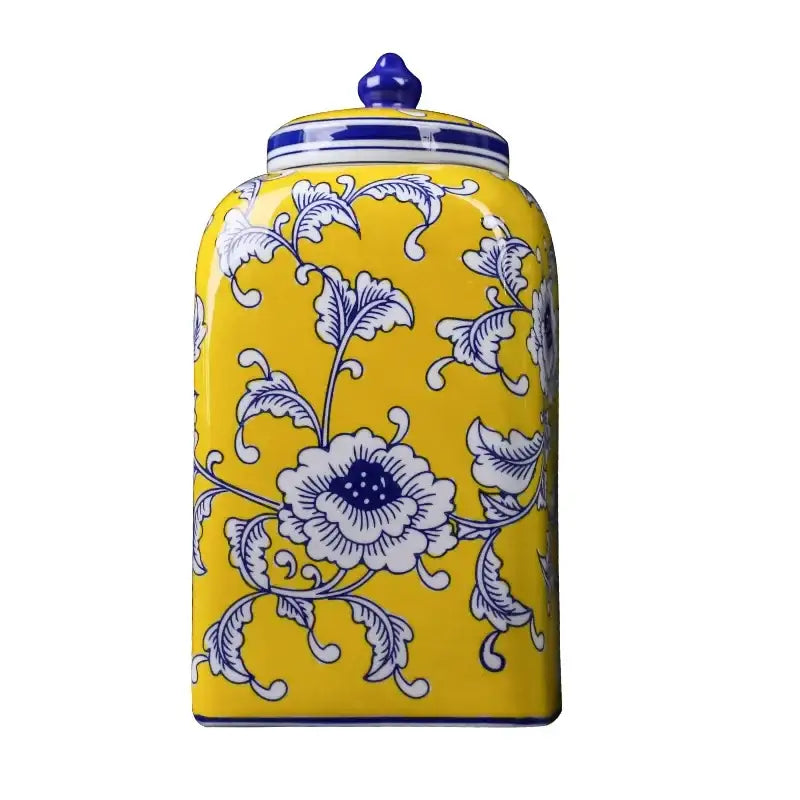 A vibrant yellow ceramic jar with blue white porcelain floral pattern and ornate lid for decorbites blue white living room decor