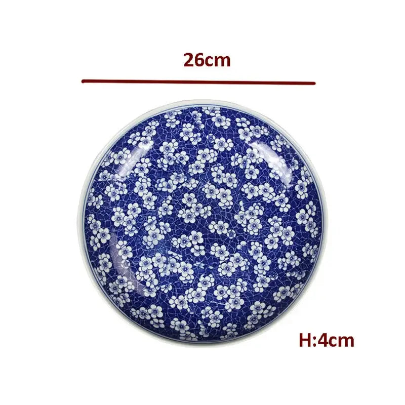 A round deep blue porcelain serving plate with white floral patterns and crackle texture for dining tableware