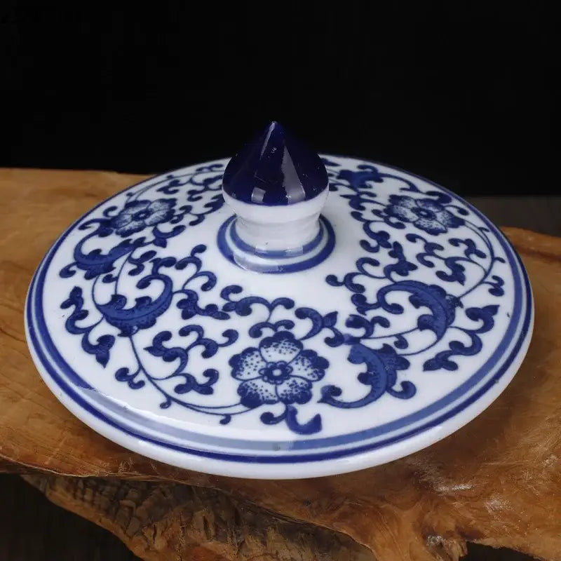 Floral blue and white porcelain storage tank with intricate patterns and glossy pointed finial by decorbites blue white