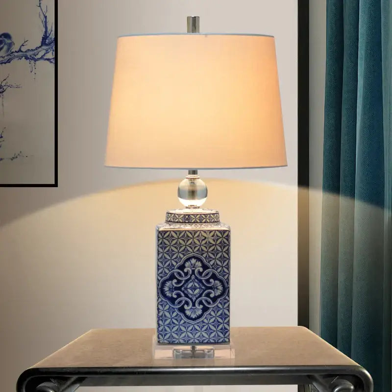 Floral blue white porcelain table lamp with intricate patterns and beige fabric shade for bedroom decorbites blue white