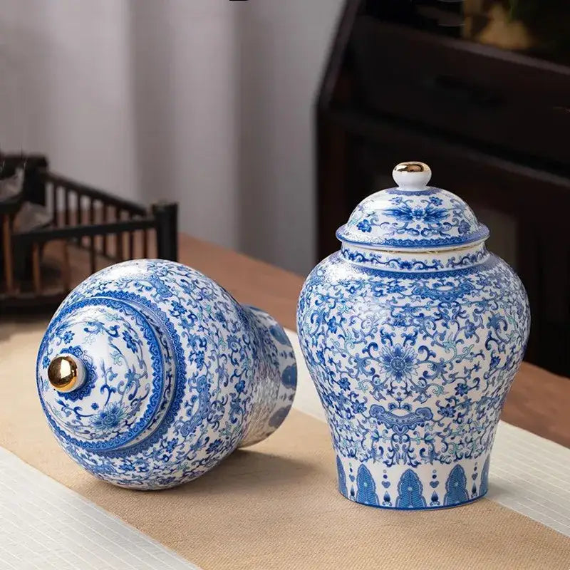 Floral blue and white porcelain tea pot storage container with intricate floral patterns and gold-toned lid knob