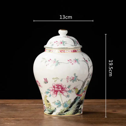 White porcelain tea pot storage container with matching lid featuring delicate pink and green floral peonies and birds
