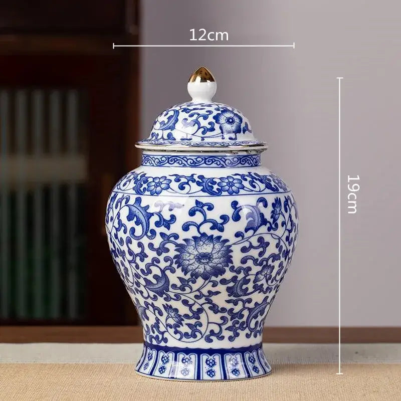 Floral blue and white porcelain tea pot storage container featuring a classic ginger jar design with gold-tipped lid