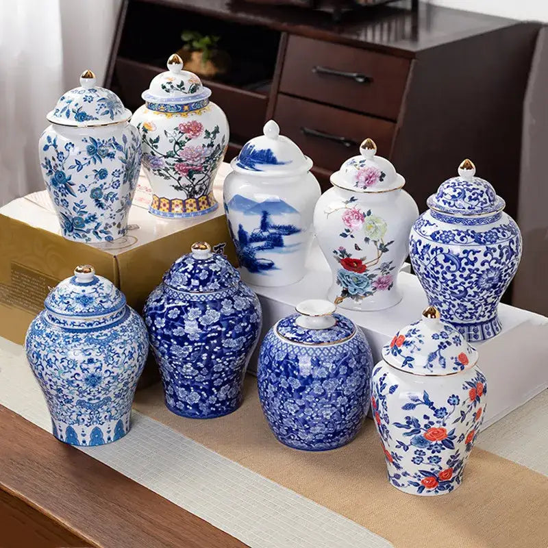 A collection of floral blue and white porcelain tea pot storage containers with gold accented lids for kitchen use