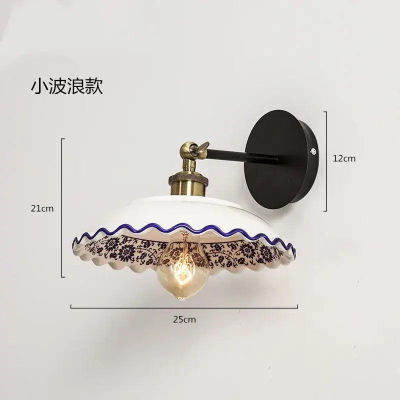 White ceramic wall lamp with black floral pattern blue white porcelain decorbites design and brass-finished arm