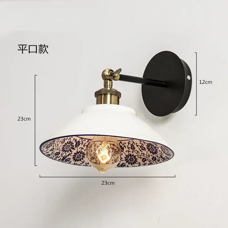 White ceramic wall lamp with black floral patterned interior, brass hardware, and matte black mounting plate decorbites blue white porcelain