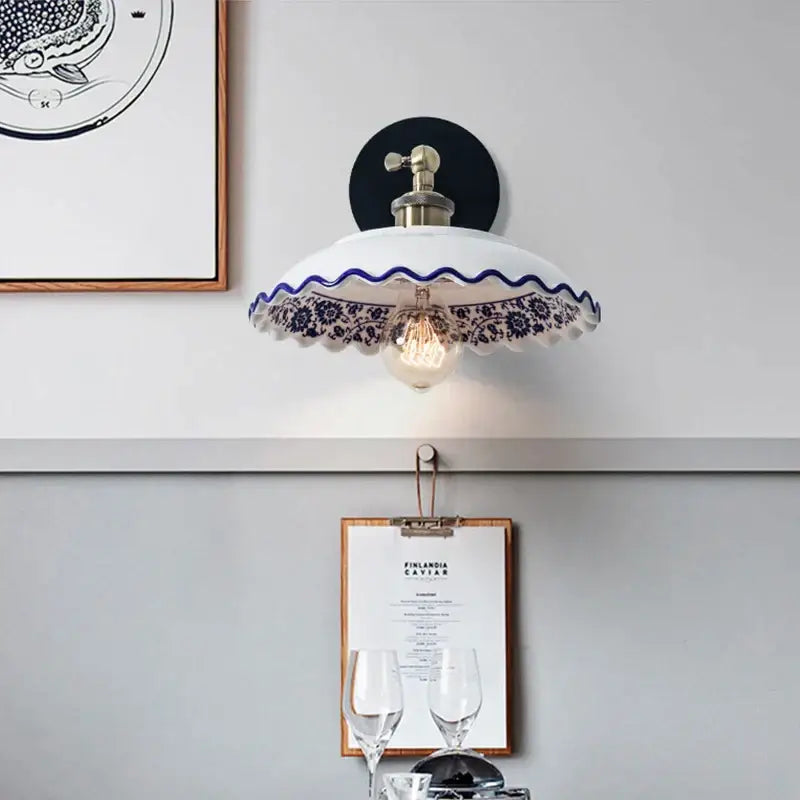 White ceramic wall lamp with blue floral pattern and scalloped edge featuring brass fixture decorbites blue white porcelain