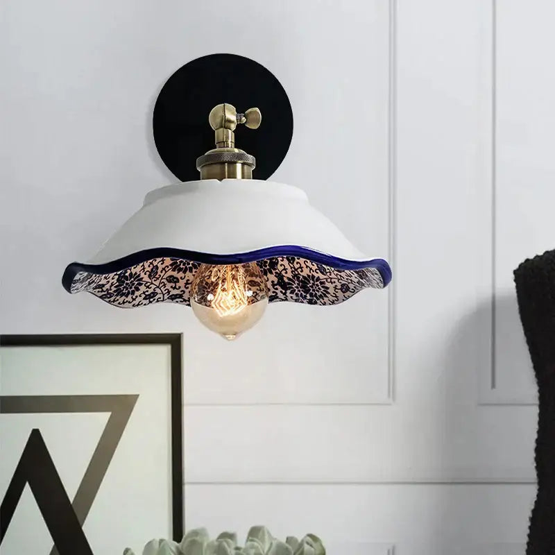 White ceramic wall lamp with scalloped edge navy blue floral lace trim and brass hardware from decorbites blue white porcelain