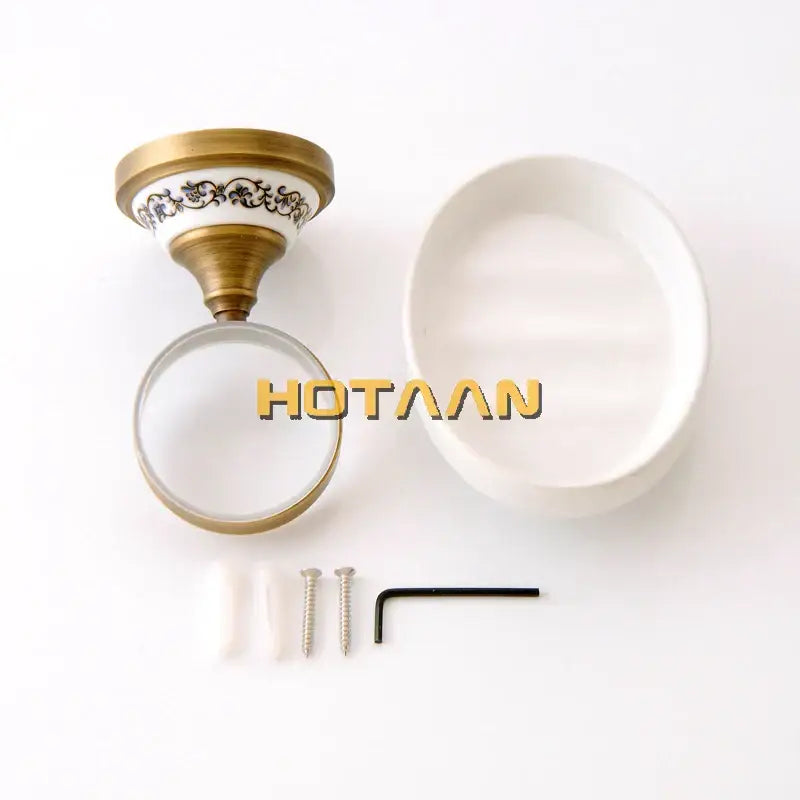 Floral brass soap holder with white ceramic dish and decorbites brass soap mounting bracket featuring black floral detailing