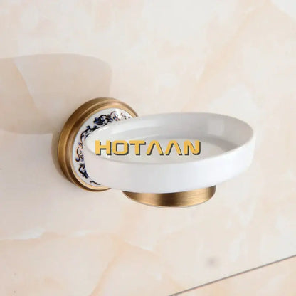 Floral brass soap holder with white ceramic dish featuring gold-toned metal mounting and blue floral decorbites brass soap design