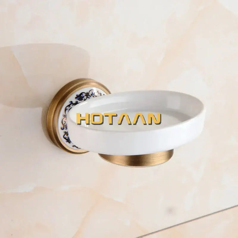 Floral brass soap holder with white ceramic dish featuring gold-toned metal mounting and blue floral decorbites brass soap design