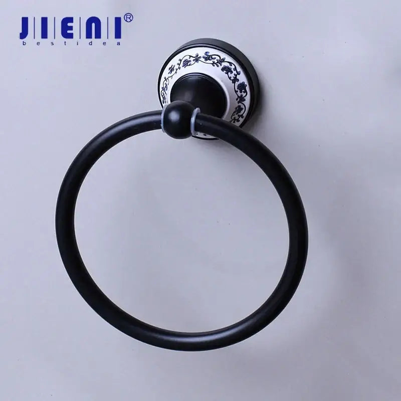 Black stainless steel towel ring with black matte finish and white floral ceramic backplate for bathroom decorbites decor