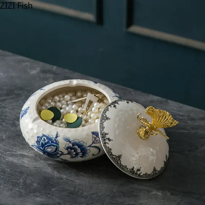White ceramic floral jewelry box with decorbites dragonfly lid filled with pearls and earrings for bedroom storage