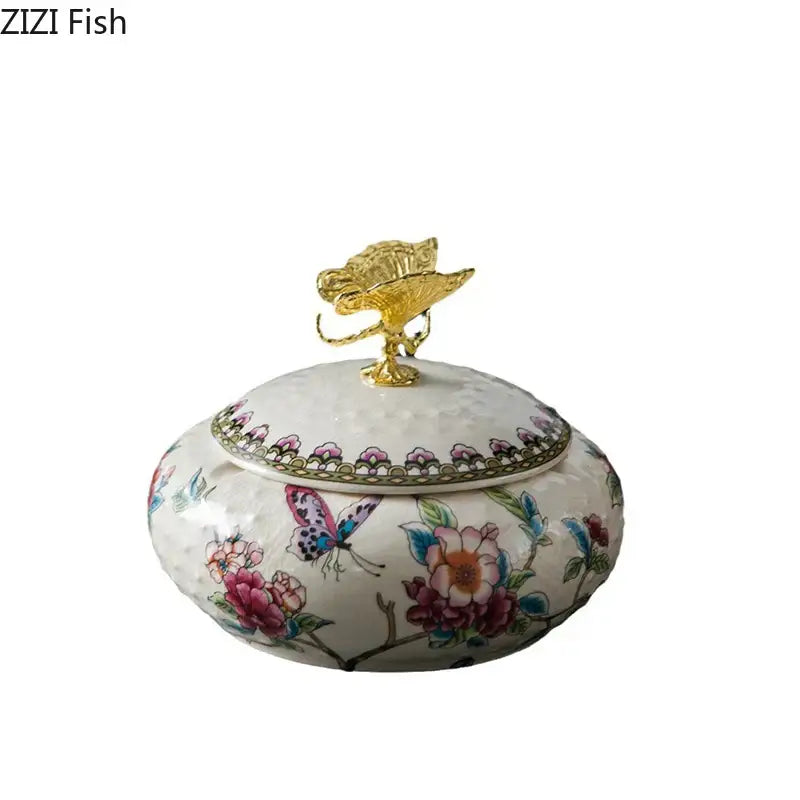 A delicate white porcelain floral ceramic jewelry box with vibrant motifs and a decorbites dragonfly lid ceramic gold leaf top