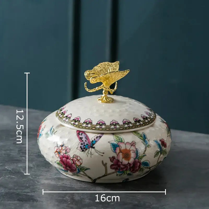 Floral ceramic jewelry box with dragonfly lid features a white base with colorful patterns and a gold leaf finial decorbites dragonfly lid ceramic jar