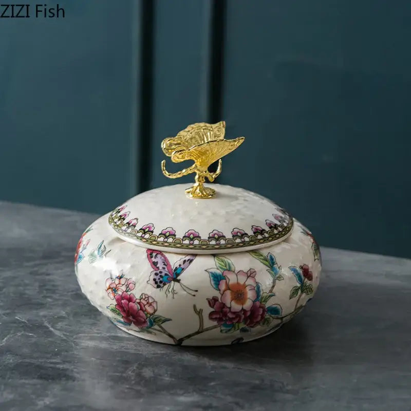 A white porcelain floral ceramic jewelry box with vibrant patterns and a golden decorbites dragonfly lid for bedroom storage