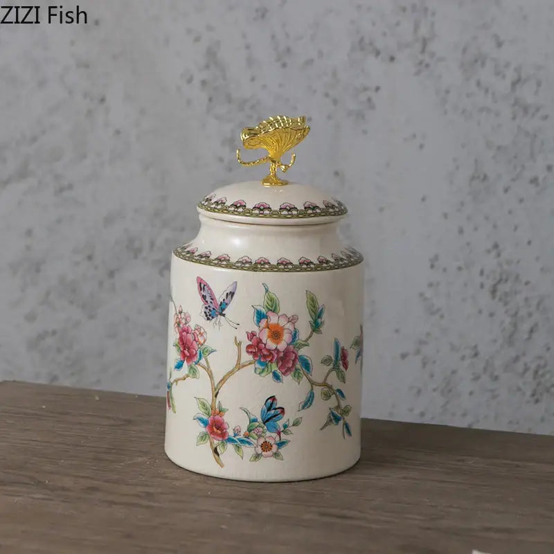 Ivory floral ceramic storage jar with vibrant motifs and golden fish finial featuring decorbites dragonfly lid