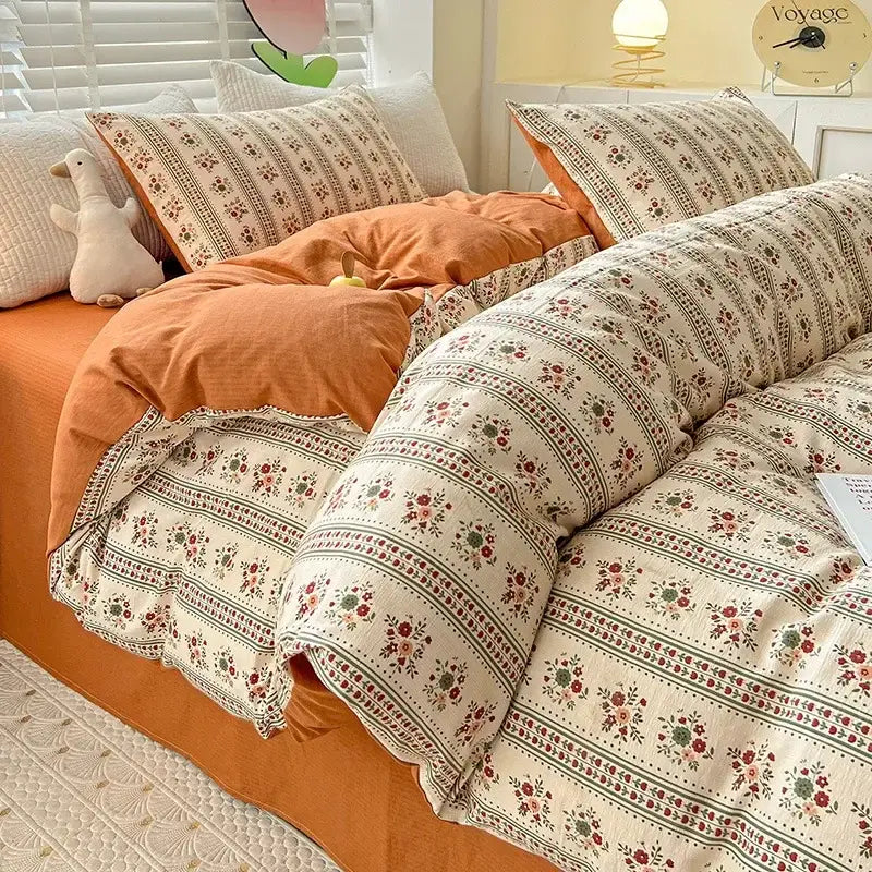 Floral cream and peach double layer cotton quilt cover set featuring delicate floral and striped patterns in muted tones