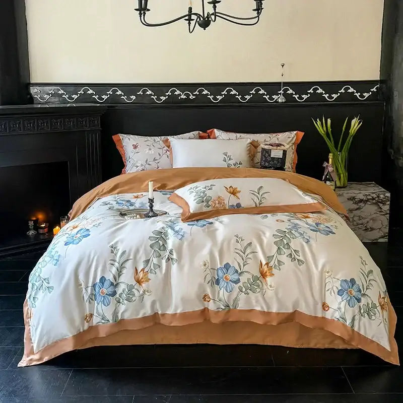 Cream-colored satin duvet cover with blue and gold floral embroidery and caramel border in egyptian cotton bedding set