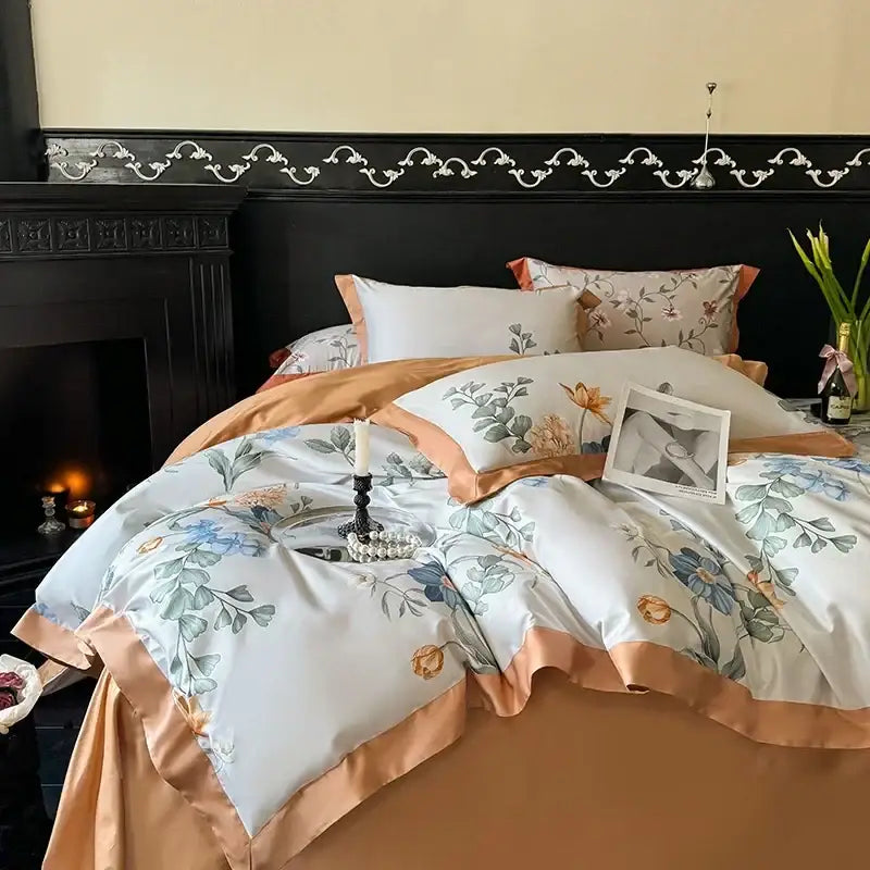 Elegant white satin duvet cover with blue and orange floral embroidery and peach trim in egyptian cotton bedding set