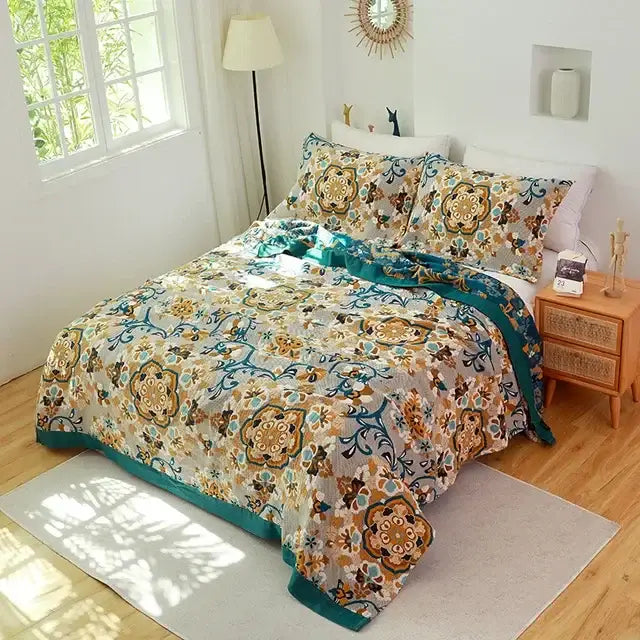 A cozy double gauze cotton summer blanket with vibrant teal gold and brown floral mandala designs on a cream background